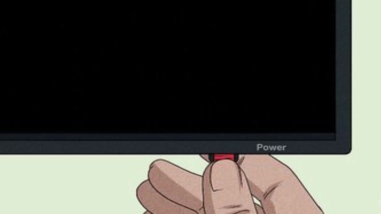 Doigt appuyant sur le bouton Power sous le bord d’un téléviseur, télé débranchée